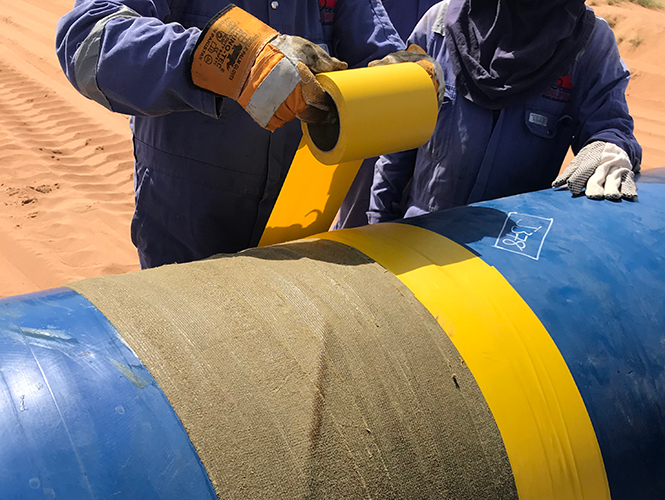 Densyl Tape being overwrapped with Denso Self-Adhesive PVC Tape